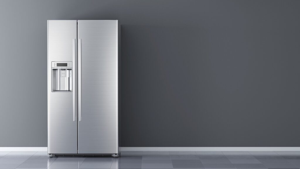 Hardwired vs Plug-In Appliances Silver refrigerator in an empty room