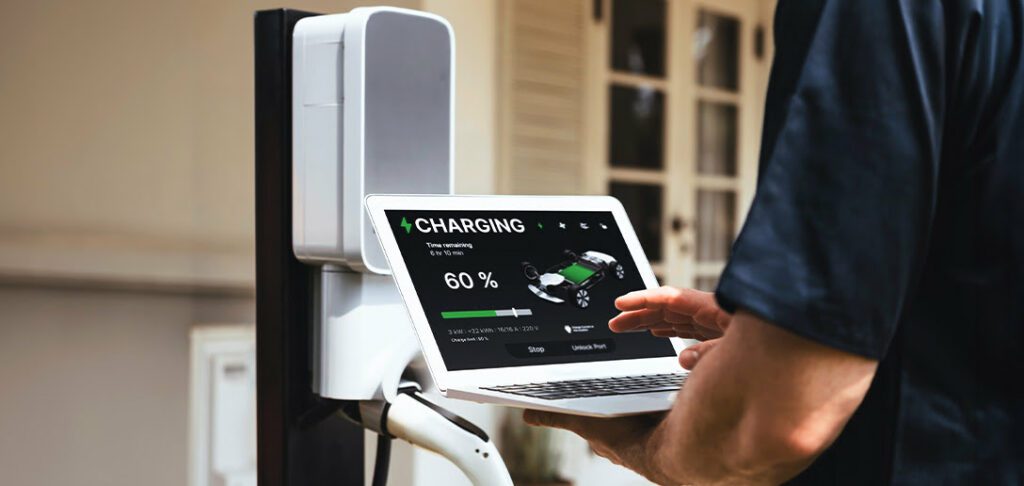 Electrician running diagnostic on home EV charger after installation